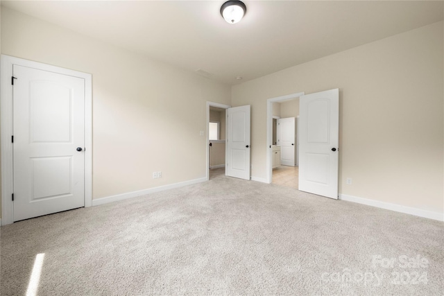 unfurnished bedroom with light carpet