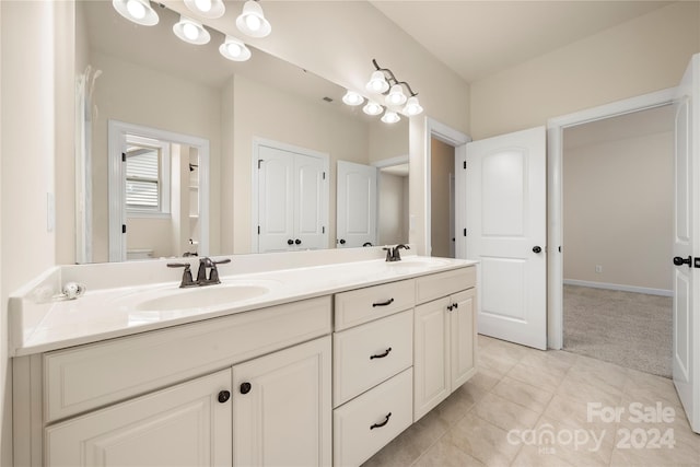 bathroom featuring tile patterned flooring and vanity