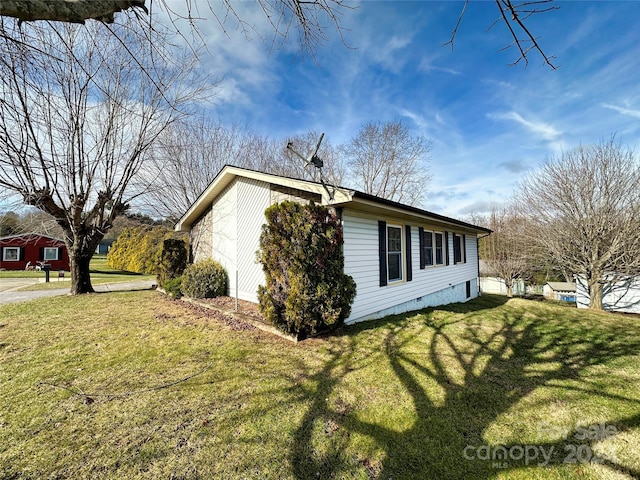 view of side of property with a lawn