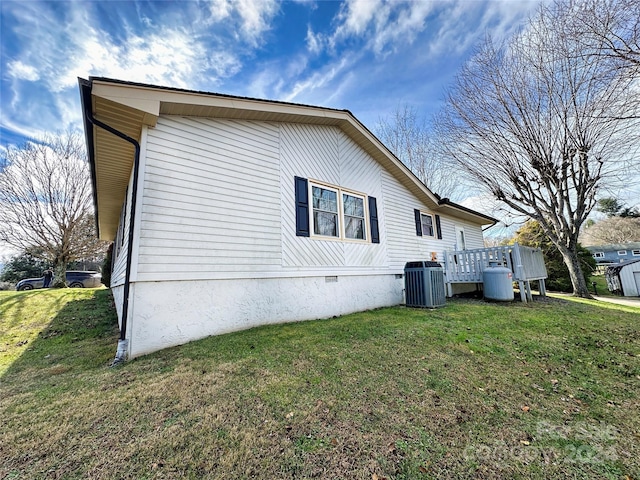 view of home's exterior featuring a lawn, central AC, and a wooden deck