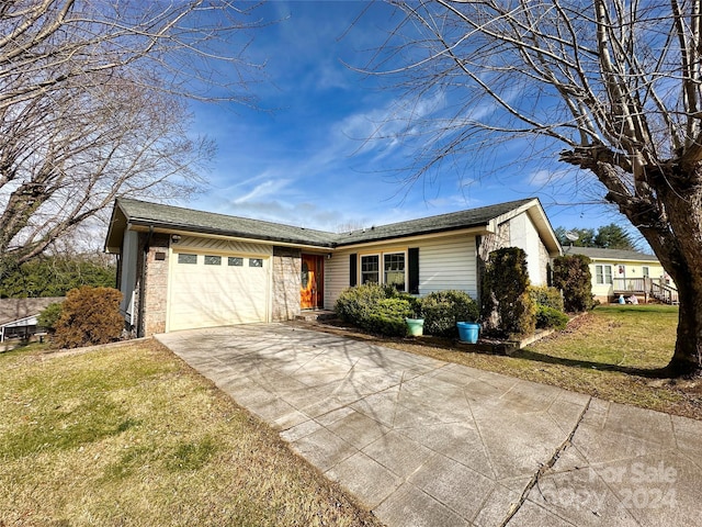 ranch-style home with a front yard and a garage