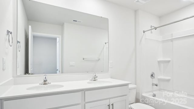 full bathroom featuring toilet, double vanity, a sink, and visible vents