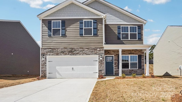 craftsman inspired home featuring stone siding, a front lawn, an attached garage, and driveway