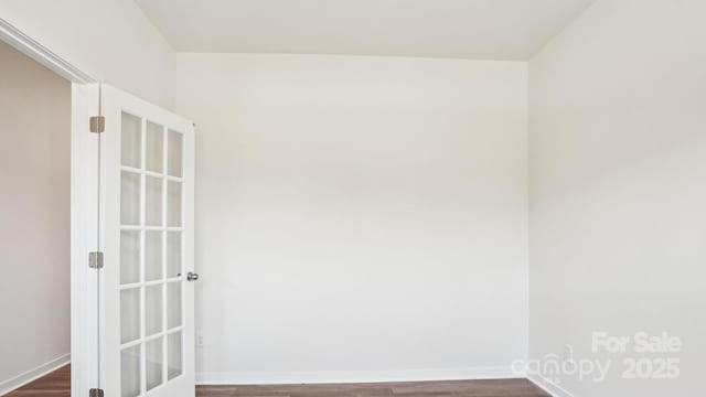 unfurnished room featuring dark wood finished floors and baseboards