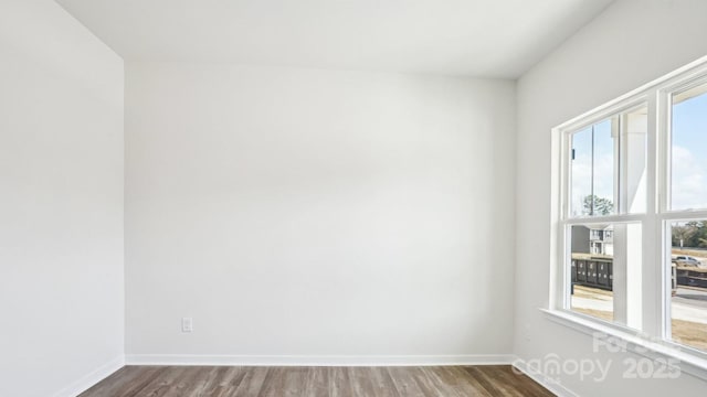 empty room with wood finished floors and baseboards