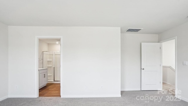 unfurnished bedroom featuring carpet floors, visible vents, and baseboards