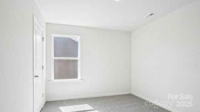 carpeted empty room featuring visible vents and baseboards