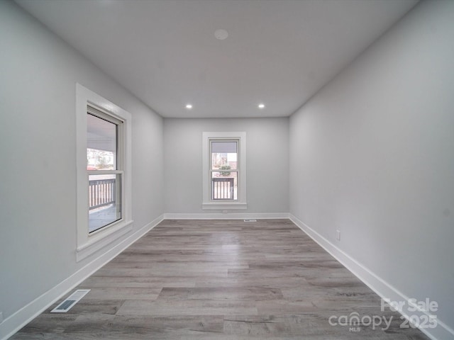 unfurnished room with light wood-type flooring