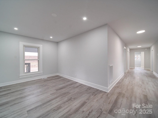 spare room featuring light hardwood / wood-style floors