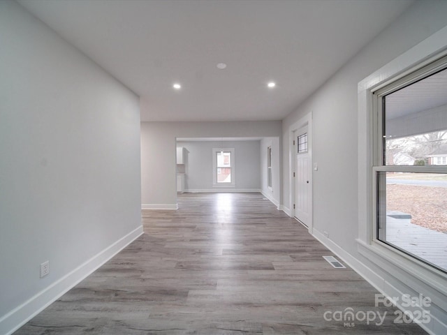 hall with light hardwood / wood-style flooring