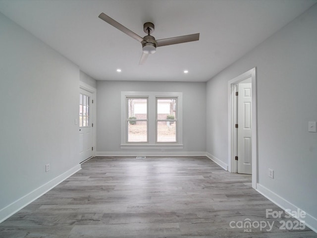 spare room with ceiling fan and light hardwood / wood-style flooring