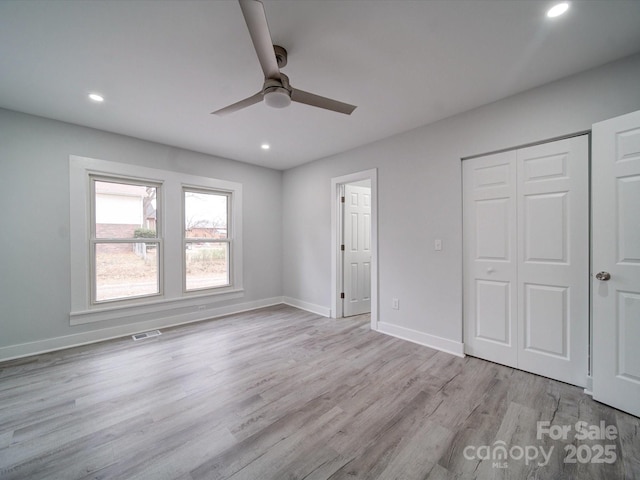 unfurnished bedroom with ceiling fan, a closet, and light hardwood / wood-style floors