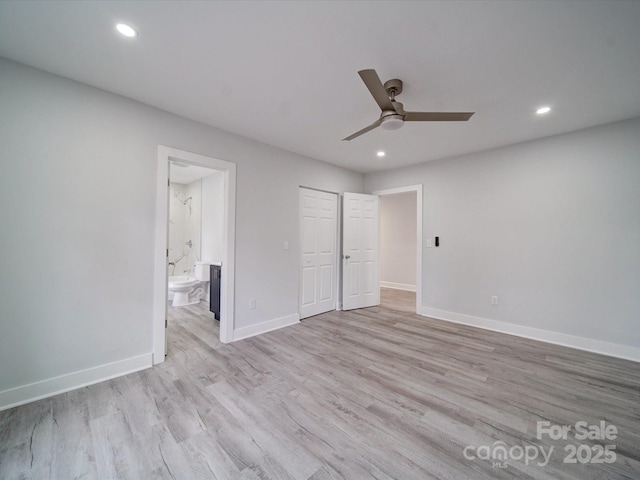 unfurnished bedroom featuring light wood-type flooring, ceiling fan, a closet, and connected bathroom