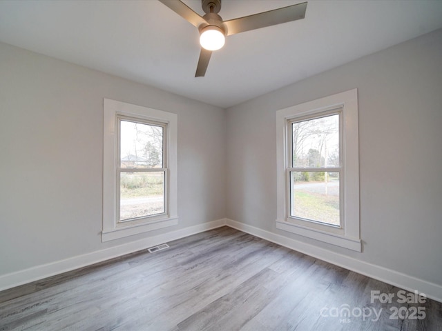 spare room with ceiling fan and wood-type flooring