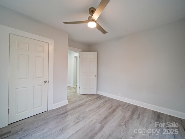 unfurnished bedroom with ceiling fan and light hardwood / wood-style floors