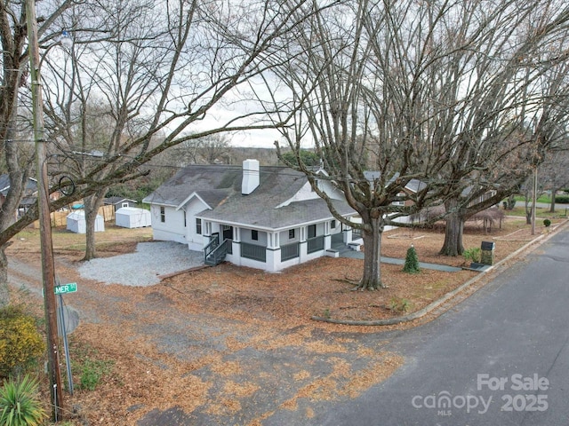 view of front of home featuring a storage shed and a sunroom