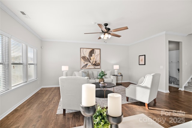 living room featuring ceiling fan, ornamental molding, and dark wood-type flooring