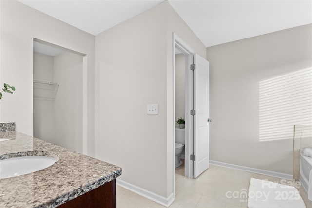 bathroom with tile patterned floors, vanity, and toilet