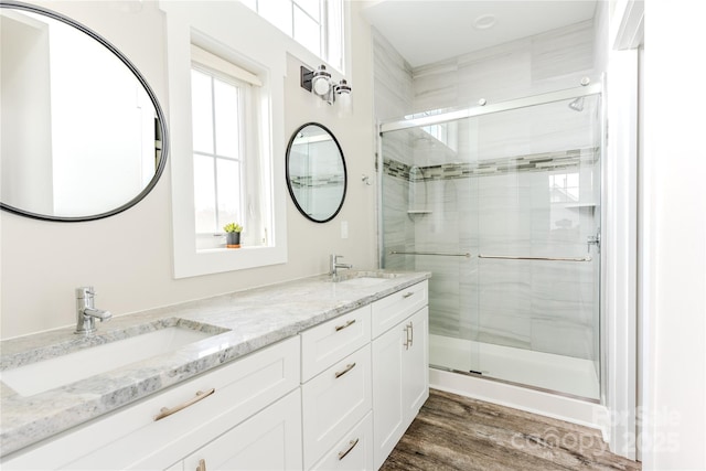 bathroom with vanity, hardwood / wood-style flooring, and walk in shower