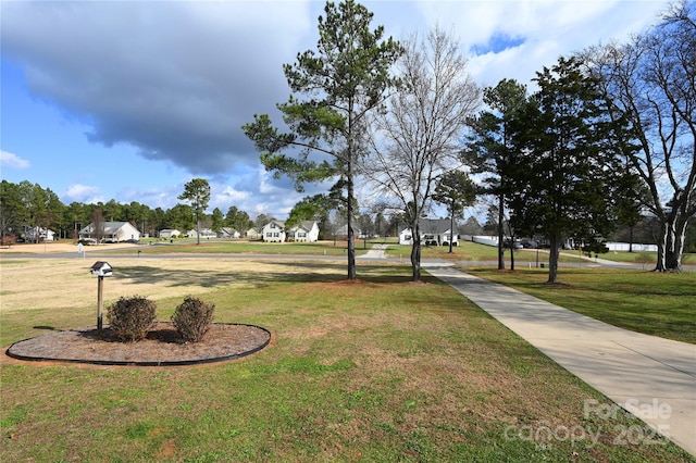 view of property's community with a lawn