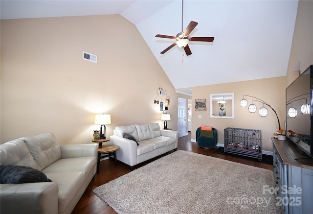 living room with ceiling fan, dark hardwood / wood-style flooring, and high vaulted ceiling