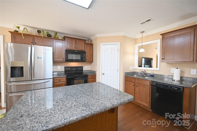 kitchen with black appliances, sink, crown molding, hanging light fixtures, and light stone counters