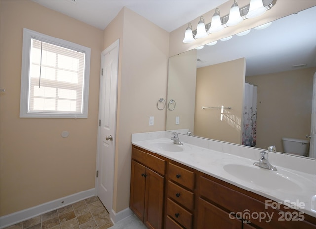 bathroom featuring toilet and vanity