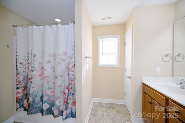 bathroom featuring vanity and curtained shower