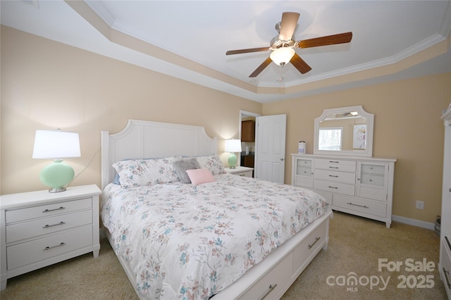 bedroom with ceiling fan, a tray ceiling, crown molding, and light carpet