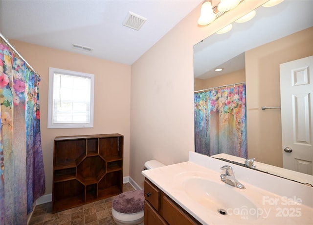 bathroom featuring toilet and vanity