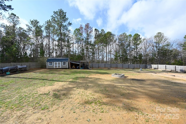 view of yard featuring an outdoor fire pit and a storage unit