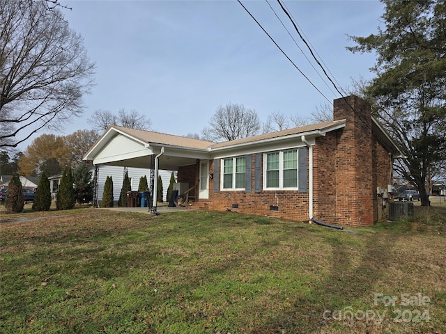 ranch-style house featuring central AC and a front lawn