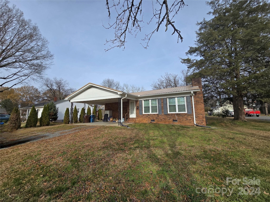 ranch-style house with a front lawn and a carport