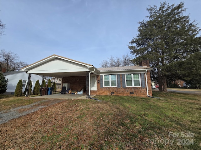 single story home with a front lawn and a carport