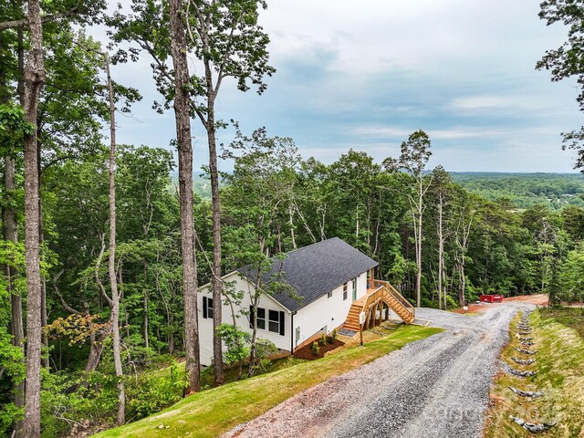 430 Hague Dr, Columbus, NC 28722 - exterior space with a view of trees, stairs, gravel driveway, and a shingled roof