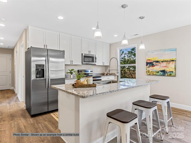 430 Hague Dr, Columbus, NC 28722 - kitchen featuring stainless steel appliances, a sink, light wood finished floors, white cabinetry, and baseboards