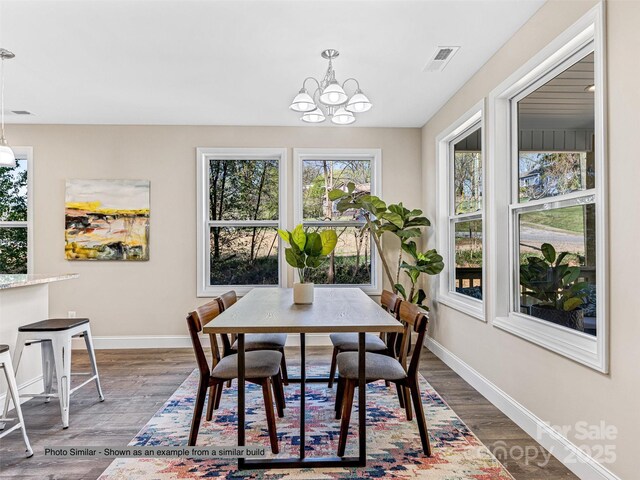 430 Hague Dr, Columbus, NC 28722 - dining space with a chandelier, dark wood finished floors, and baseboards