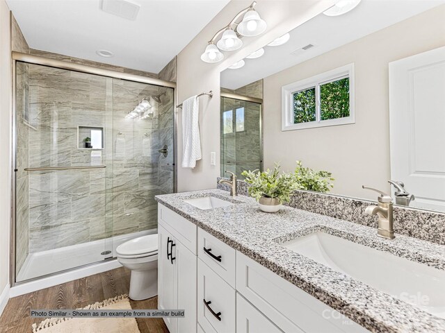 430 Hague Dr, Columbus, NC 28722 - full bath with toilet, double vanity, a stall shower, and wood finished floors