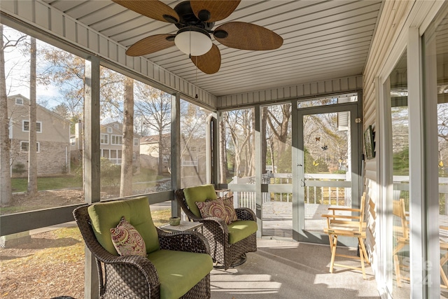 sunroom featuring ceiling fan, a wealth of natural light, and wood ceiling