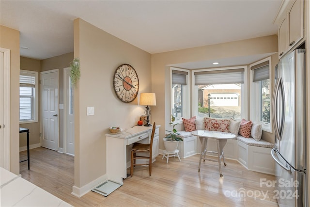 interior space featuring breakfast area, light hardwood / wood-style flooring, and a wealth of natural light