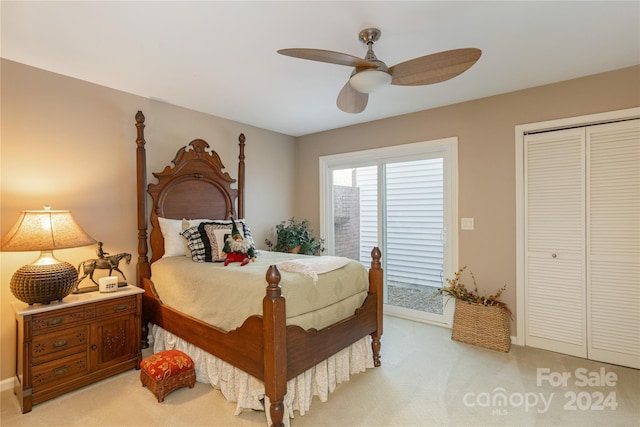 carpeted bedroom featuring ceiling fan and a closet