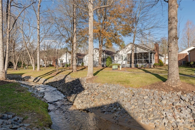 view of yard featuring a sunroom