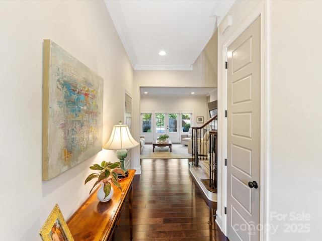 hall featuring dark wood-type flooring, ornamental molding, and french doors