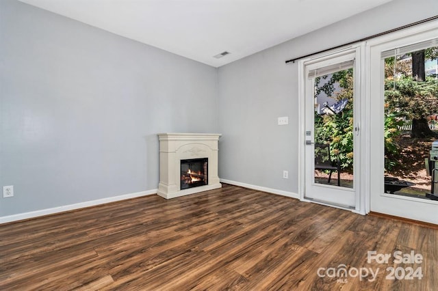 unfurnished living room with dark hardwood / wood-style floors