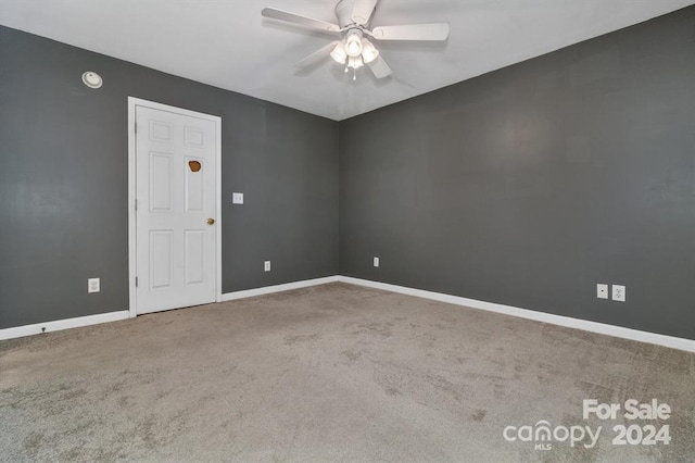 empty room with ceiling fan and carpet floors