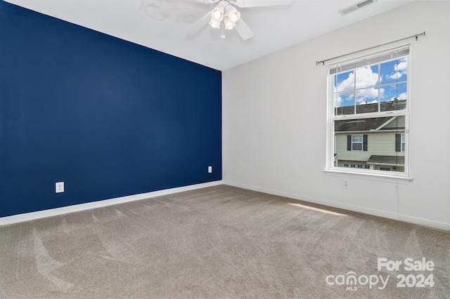 spare room featuring carpet and ceiling fan