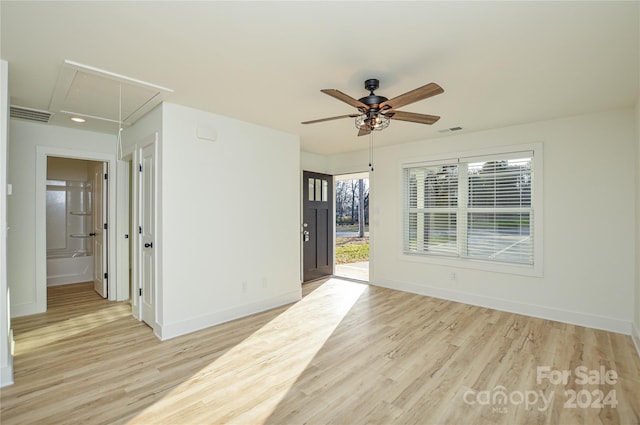 empty room with light hardwood / wood-style floors and ceiling fan