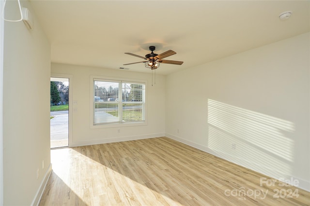 spare room featuring light hardwood / wood-style flooring and ceiling fan