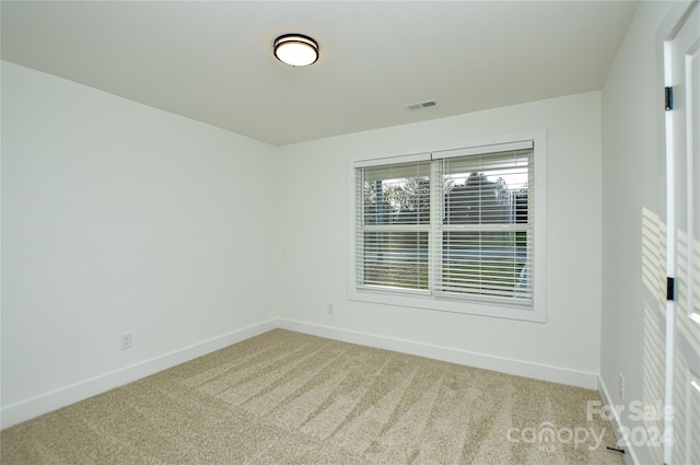 empty room featuring light carpet