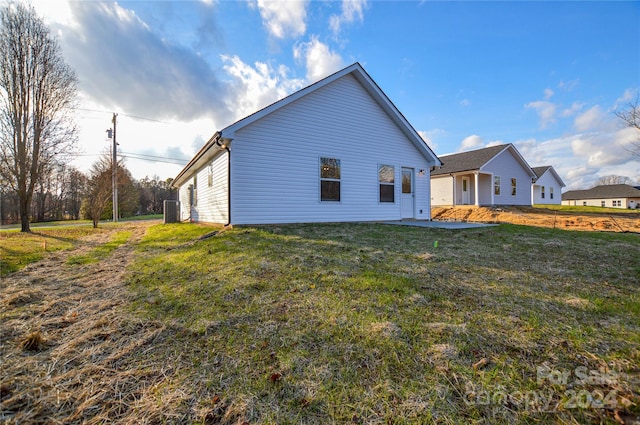 rear view of property with a yard